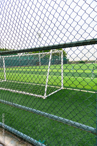 a soccer field behind the fence