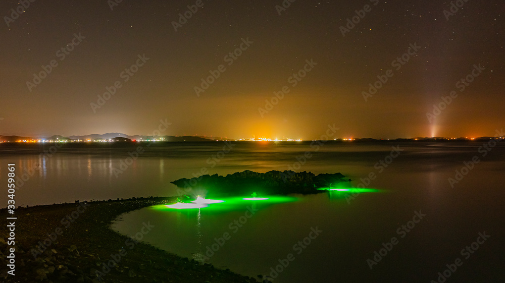 Fototapeta premium Night fishing on the west coast of a small island