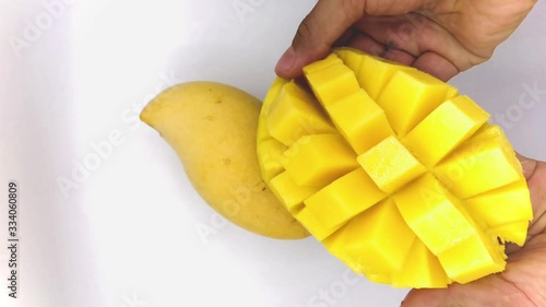 Yellow  mango slice with cubes isolated white background