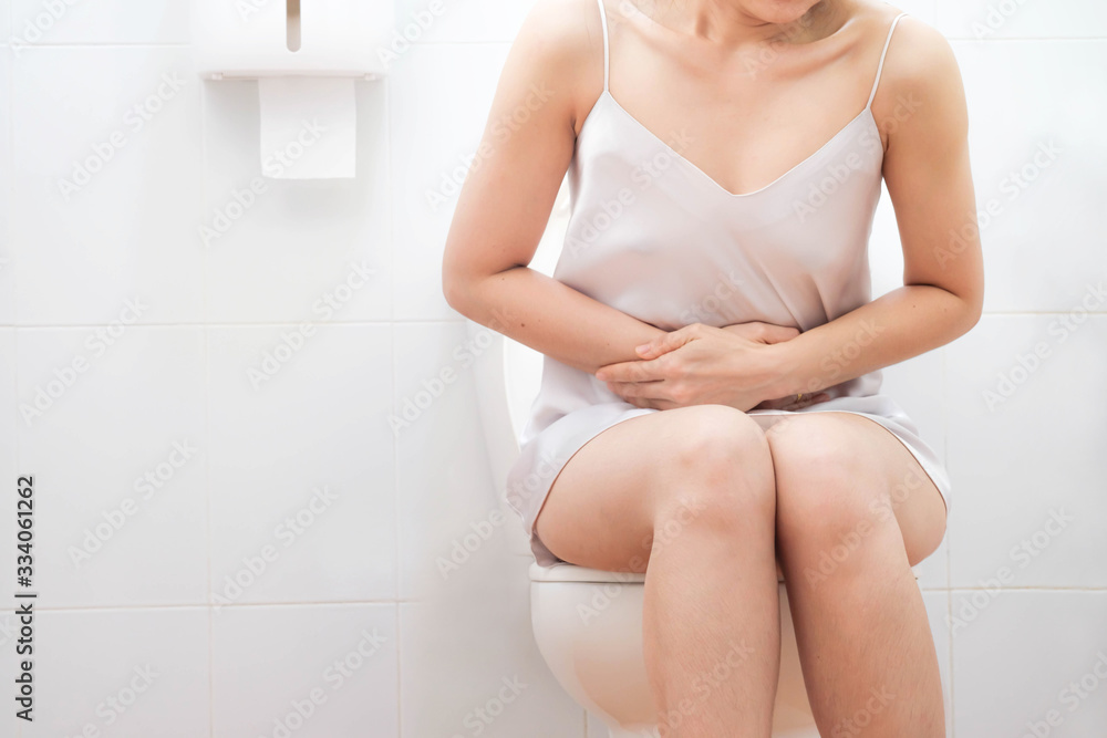 Women wearing white sleepwear,standing in the toilet, Hands holding crotch bottom, Sit on the toilet