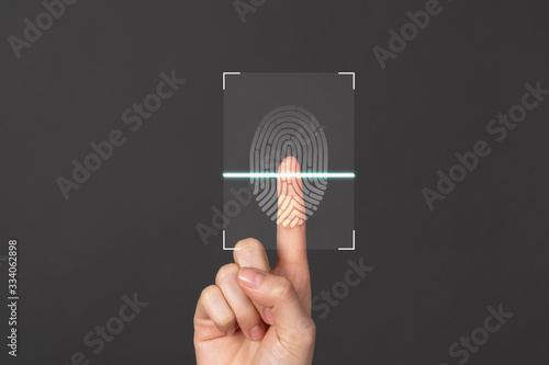 Hands show the fingerprint scanner screen to access personal user online.