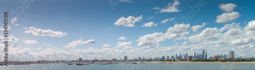 Panoramic of the city of Melbourne against a sunny blue sky seen from St Kilda pier looking through the masts of yachts in the bay, Melbourne, Victoria, Australia © fieldofvision