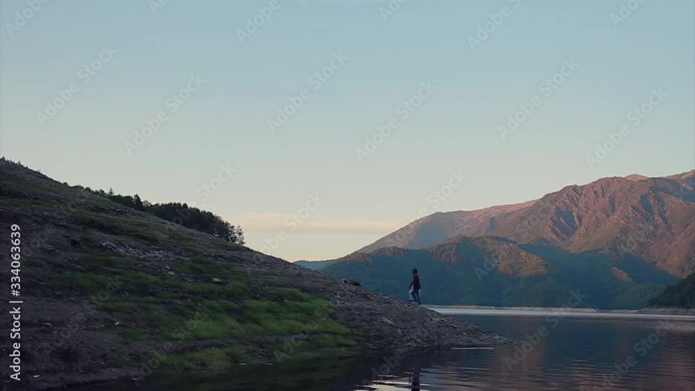 the concept of tourism, recreation, and travel - bursts of blue water in the river, mountains, and sky. A person travels. Copy space