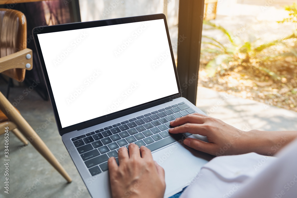 Mockup image of a woman using and typing on laptop computer with blank white desktop screen Mockup image of a woman using and typing on laptop computer with blank white desktop screen