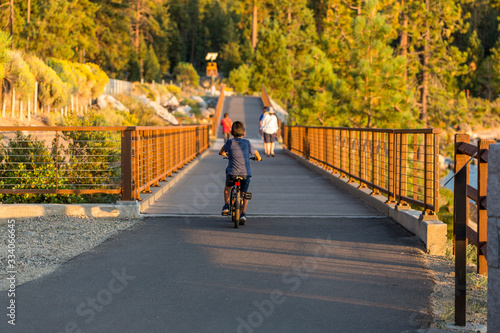 People on walking path recreational area near Lake Tahoe in evening light