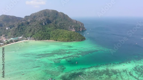 Blue ocean long tail boats in Phi Phi Island krabi thailand drone footage. phi phi viewpoint of the tonsai pier in a colorful tropical holiday. photo