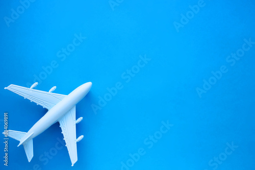 Model airplane on a blue background. Space for text. Travel concept.
