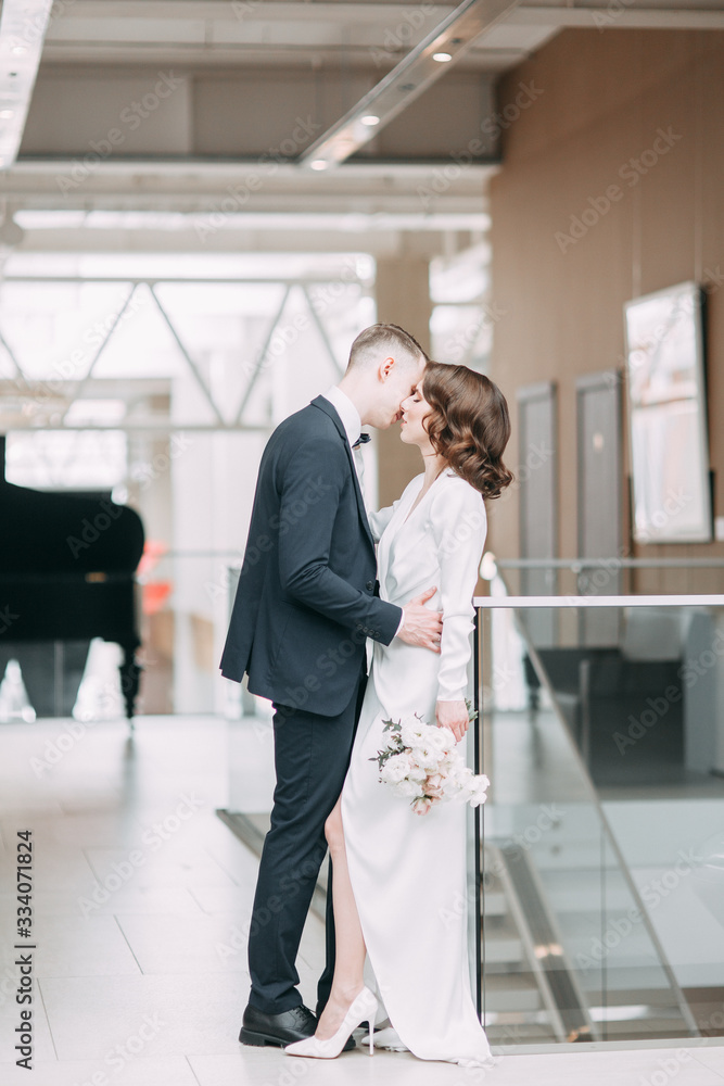 The bride and groom's romantic photo shoot. The newlyweds are happy together. Stylish modern couple in the Museum. The bride and groom's romantic photo shoot. The newlyweds are happy together. Stylish modern couple in the Museum.