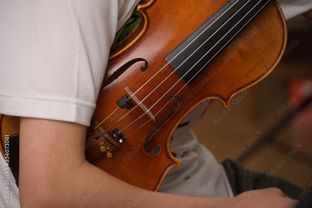 close up holding violin under arm close up holding violin under arm