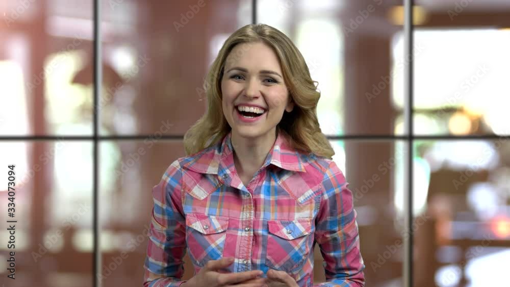 Portrait of a blond girl laughing out loud. Window background indoors. Portrait of a blond girl laughing out loud. Window background indoors.