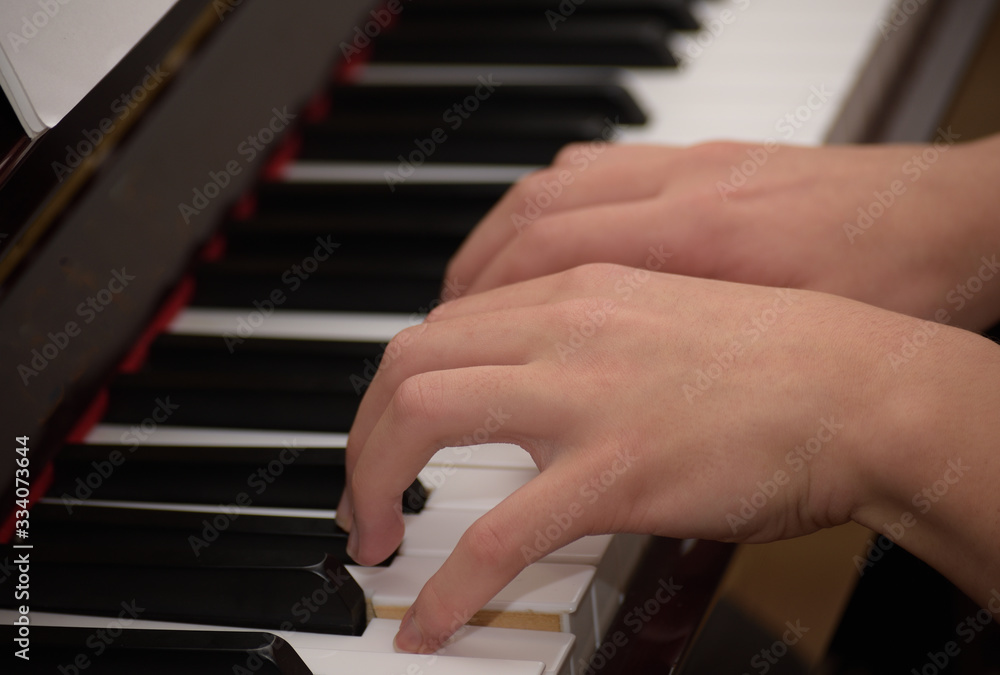 close up fingers playing piano