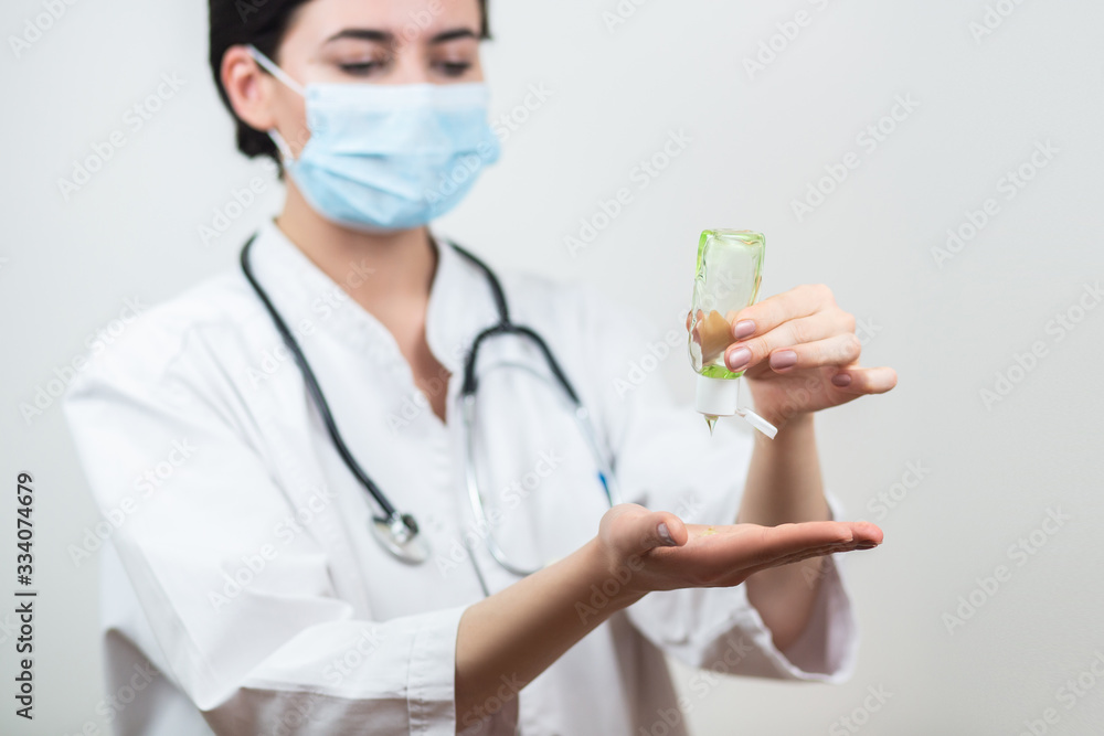 Female doctor use hand sanitizer to help prevent virus infection and plague. Female doctor use hand sanitizer to help prevent virus infection and plague.