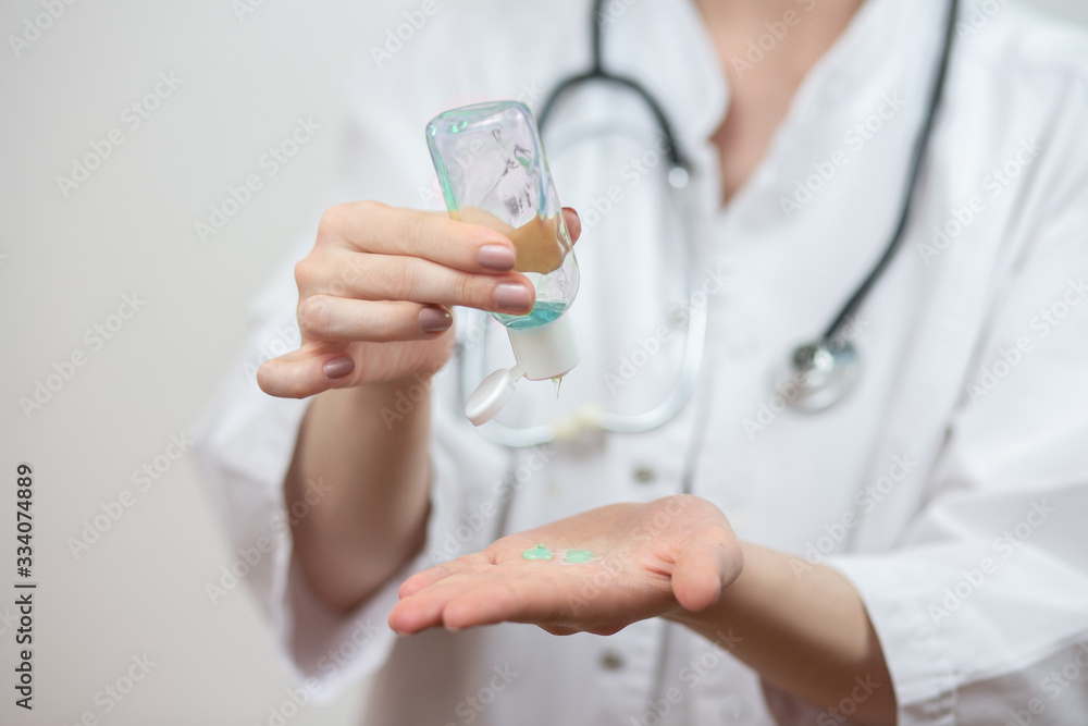 Female doctor use hand sanitizer to help prevent virus infection and plague. Female doctor use hand sanitizer to help prevent virus infection and plague.