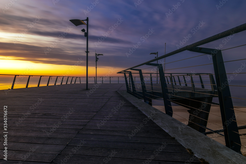 Wooden pier on the sea at dusk
