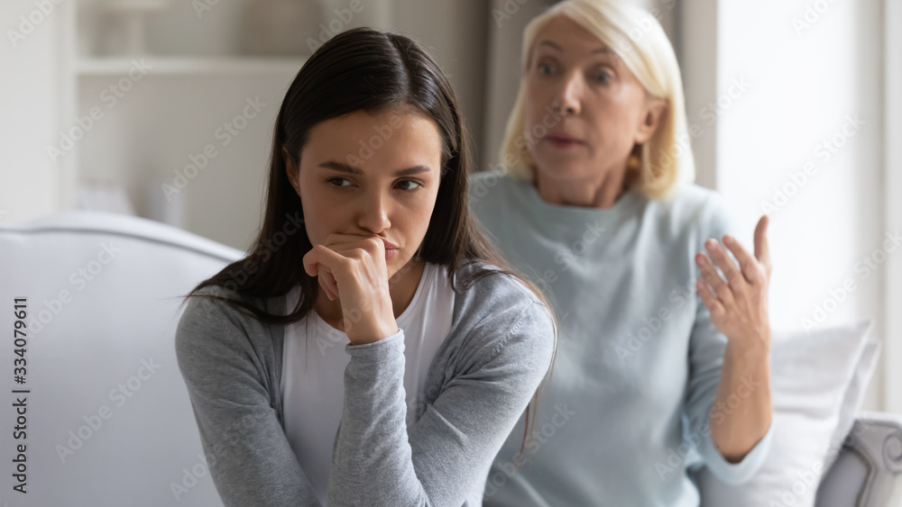 Mad bothered millennial girl annoyed by authoritative lecturing senior mother scolding quarreling, pensive distressed grown-up adult daughter ignore angry mature mom talking, generation gap concept Mad bothered millennial girl annoyed by authoritative lecturing senior mother scolding quarreling, pensive distressed grown-up adult daughter ignore angry mature mom talking, generation gap concept