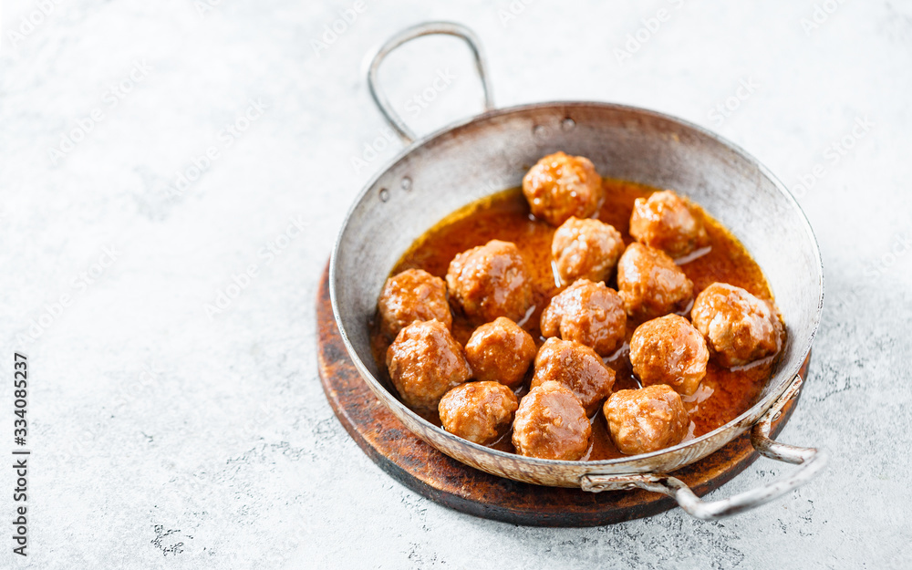 Hot meatballs in tomato sauce in a old frying pan. Homemade food. Copy space. Hot meatballs in tomato sauce in a old frying pan. Homemade food. Copy space.