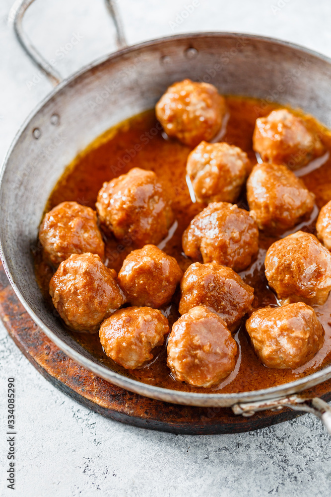 Meatballs with tomato sauce in a pan. Selective focus. Close up.