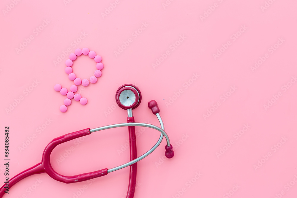 Women's Health issues. Medical concept with Venus sign and stethoscope on pink background top-down copy space Women's Health issues. Medical concept with Venus sign and stethoscope on pink background top-down copy space