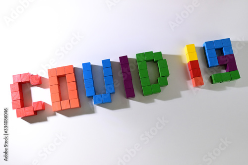 topic COVID-19 text message from wooden block toy of kid on white background