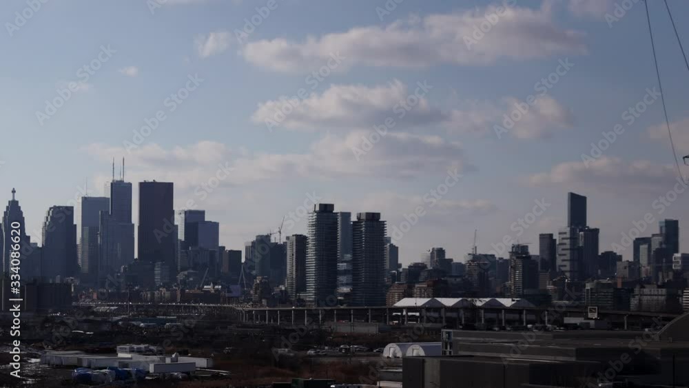 Scenic Cityscape Of Vehicles On The Road With High Rise Buildings In The Background Near The Port Of Toronto In Canada - Timelapse Scenic Cityscape Of Vehicles On The Road With High Rise Buildings In The Background Near The Port Of Toronto In Canada - Timelapse