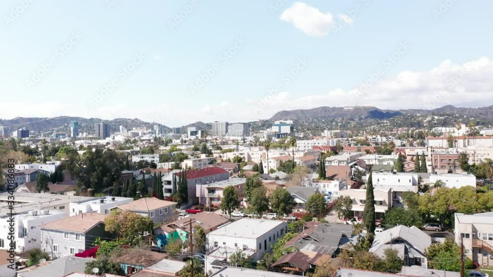Rising aerial shot of Hollywood, CA with palm tree in foreground. 4K Rising aerial shot of Hollywood, CA with palm tree in foreground. 4K