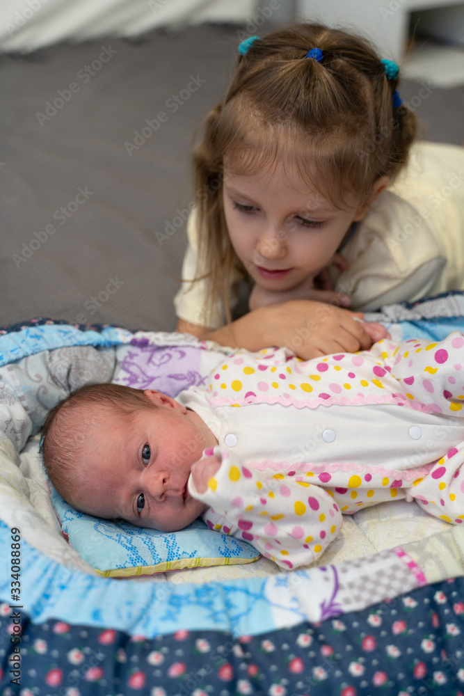 Sisters newborn and five years old Sisters newborn and five years old