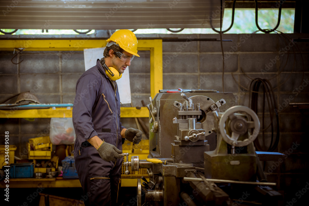 Close up portrait industry engineering wearing safety uniform control operating fixed machine working in industry factory. Close up portrait industry engineering wearing safety uniform control operating fixed machine working in industry factory.