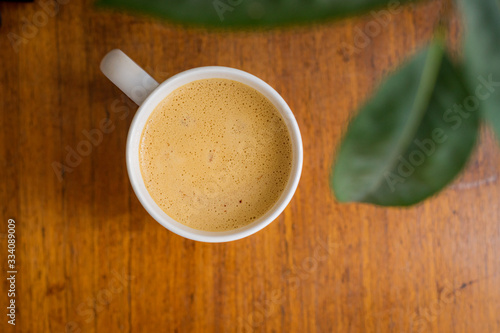 cup of coffee with a smile on wooden table