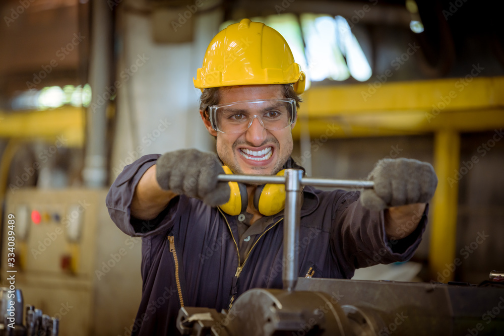 Close up portrait industry engineering wearing safety uniform control operating fixed machine working in industry factory. Close up portrait industry engineering wearing safety uniform control operating fixed machine working in industry factory.