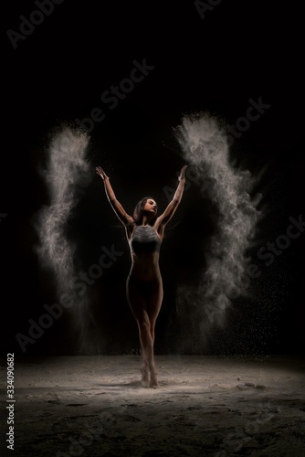 Fototapeta Naklejka Na Ścianę i Meble -  Slim girl in white dust cloud view