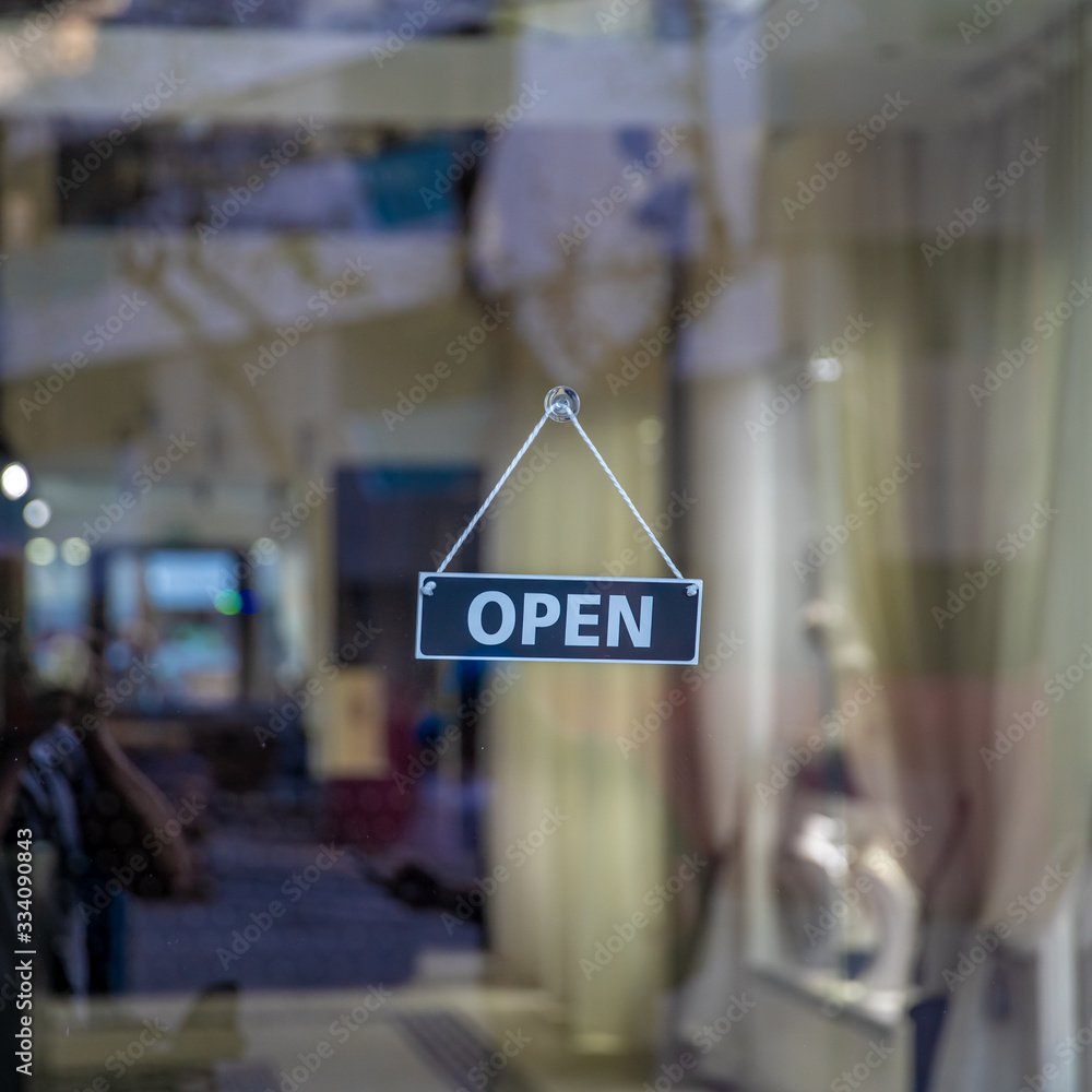 Fototapeta premium sign open on glass door of shop