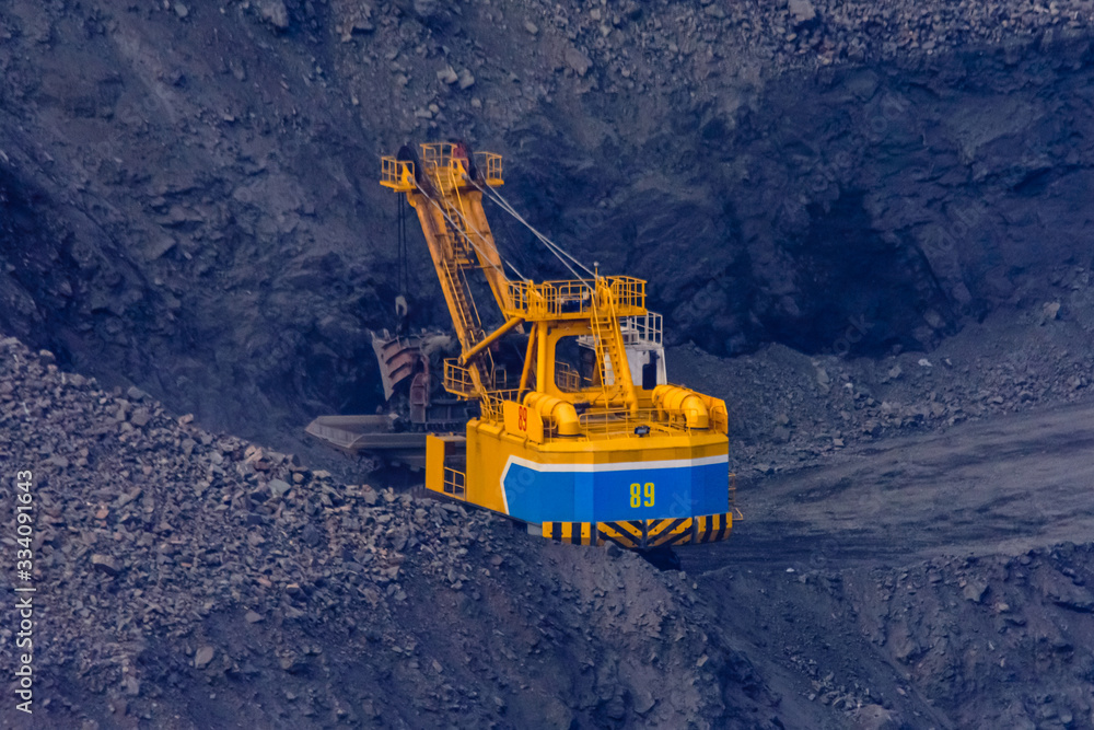 Heavy excavator working in iron ore quarry Heavy excavator working in iron ore quarry