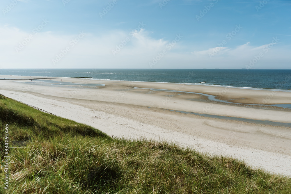 A panoramic view over the wide beach of Wangerooge, Germany on a sunny day