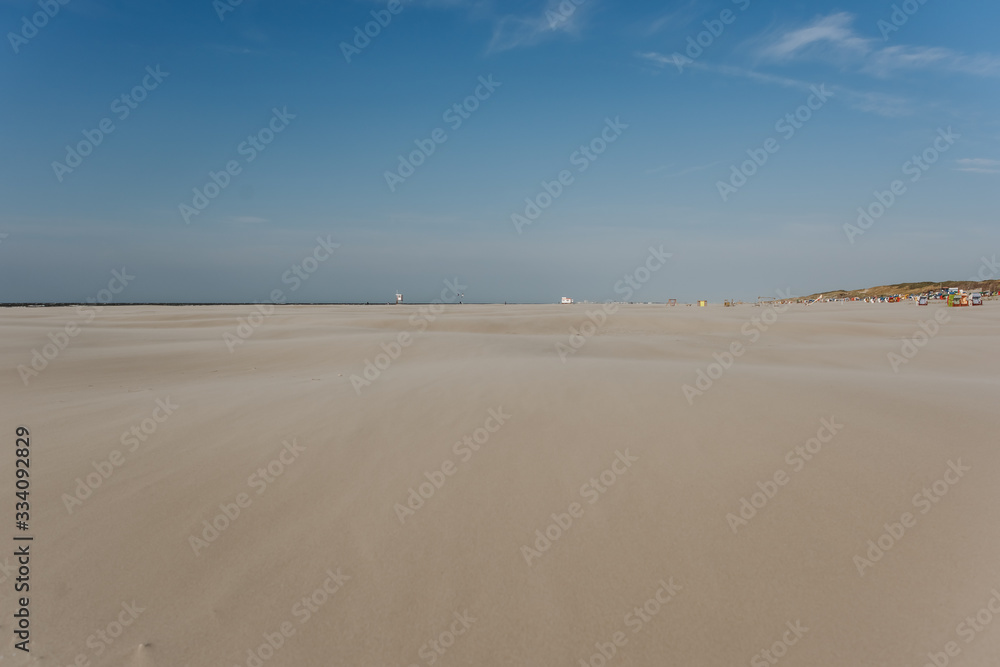 wide beach landscape on a sunny day with blue sky in summer