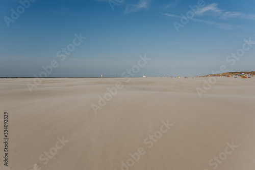 wide beach landscape on a sunny day with blue sky in summer