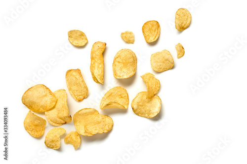 Potato chips flying. Vegan beer snack isolated on white. Crispy home made veggie chip, levitation fly creative concept. Falling potato crisps background, top view