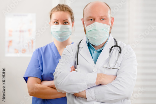 Confident and Exhausted Doctor And Nurse With Arms Crossed In Hostpital