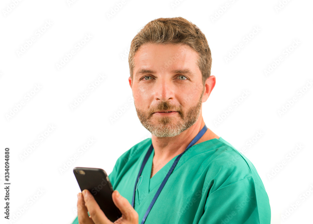 young attractive and successful medicine doctor or nurse man posing confident in green medical uniform using mobile phone smiling standing isolated on white young attractive and successful medicine doctor or nurse man posing confident in green medical uniform using mobile phone smiling standing isolated on white