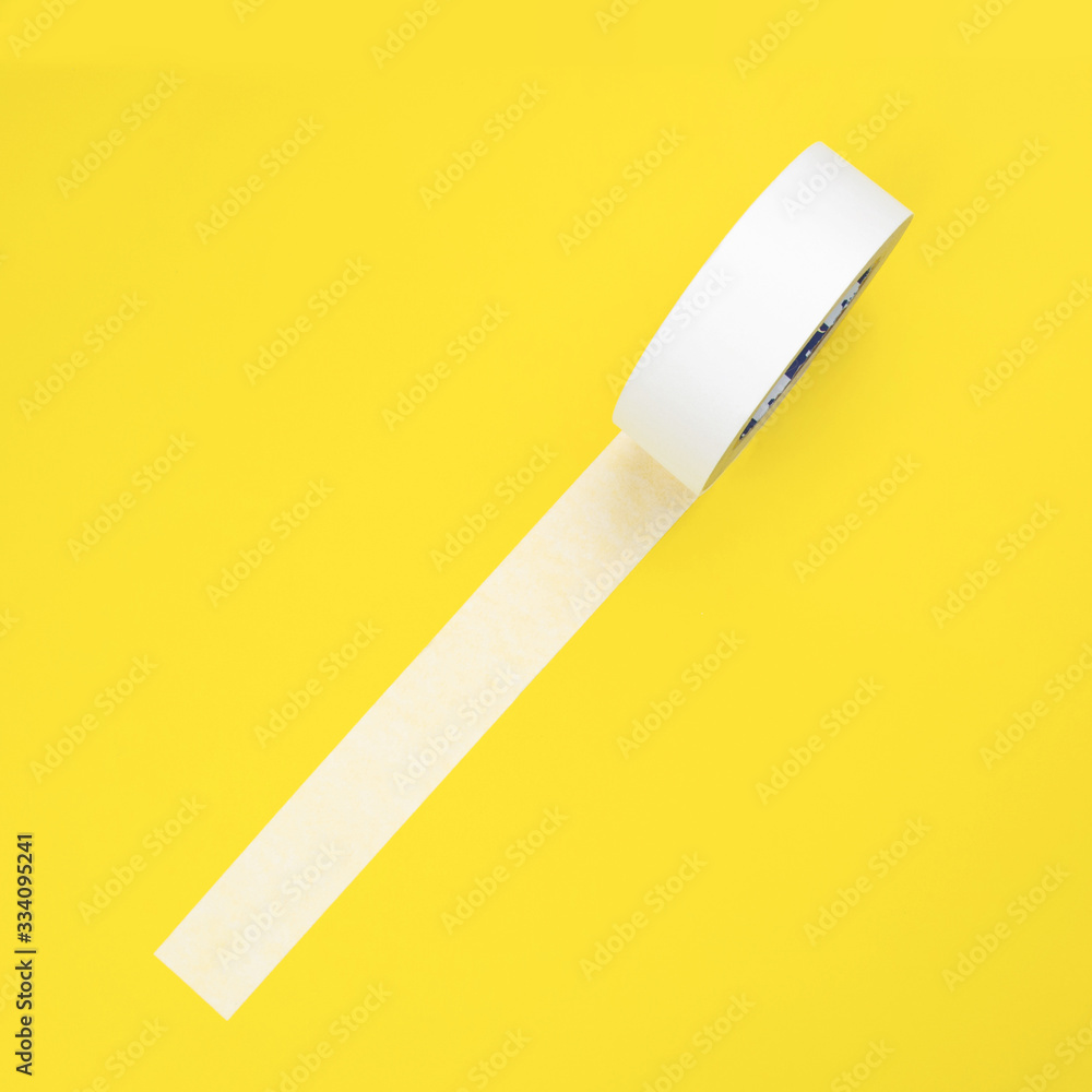 Round roll of white duct tape, adhesive tape on a yellow background. Round roll of white duct tape, adhesive tape on a yellow background.