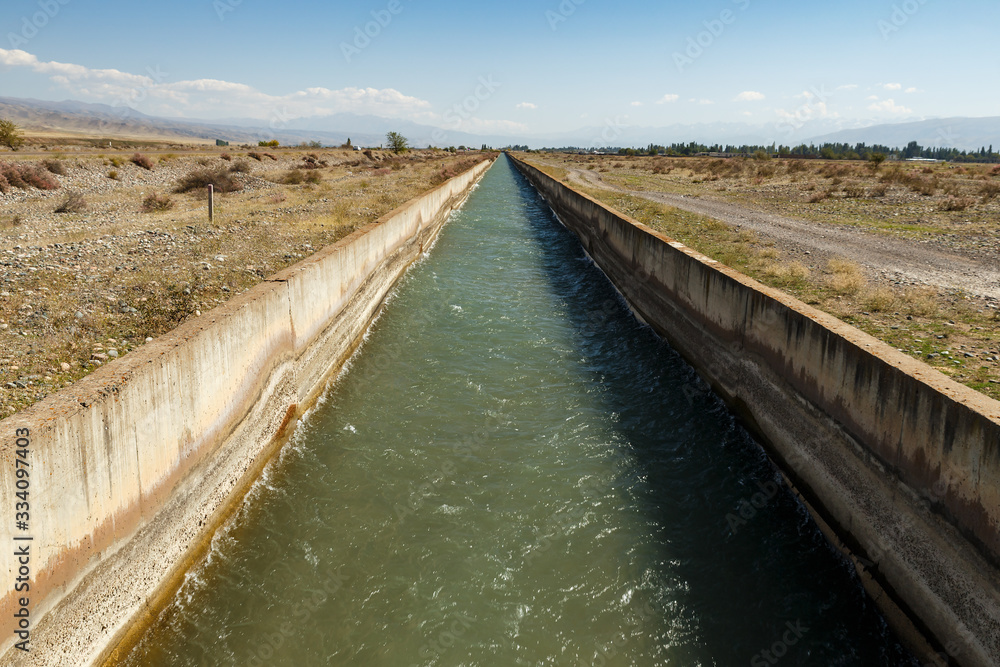 Irrigation canal Chuy Province. water flowing in an irrigation canal in Kyrgyzstan.