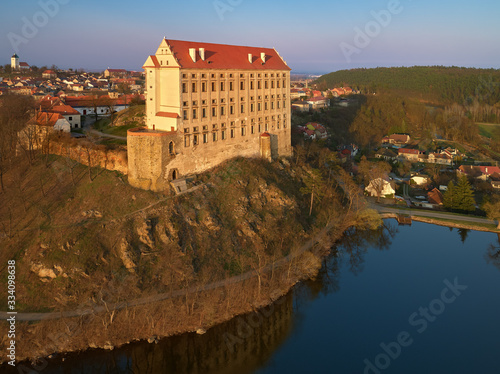 Aerial view on Chateau Plumlov, standing on a promontory above the surface of Plumlov Lake, designed by Prince Karl Eusebius of Liechtenstein. Plumlov chateau, central Moravia, Czech landscape. photo