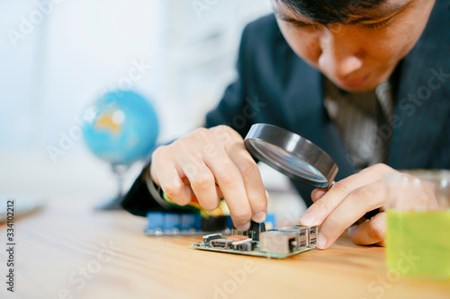 Stem educations,inventor school Creating robotics project,School boys planning of innovation robot model in laptop,microcontroller Circuit board Analysis assembly,DIY robot in science education class photo