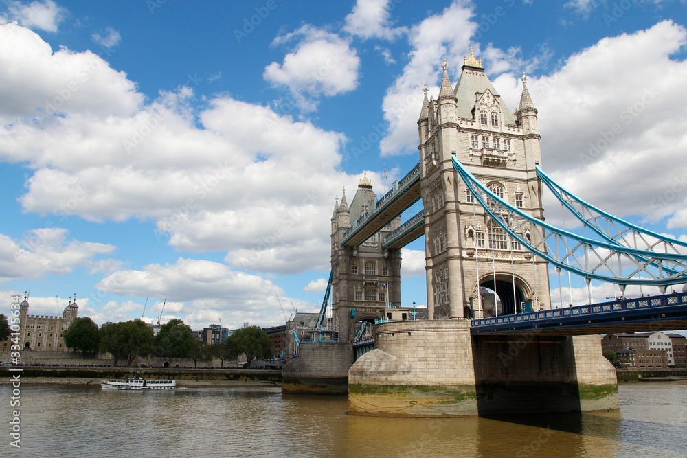 Tower Bridge with the blue sky and clouds on a bright sunny day in spring, London, UK
