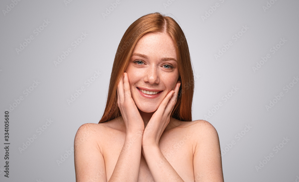 Delighted ginger woman with beautiful skin looking at camera Delighted ginger woman with beautiful skin looking at camera