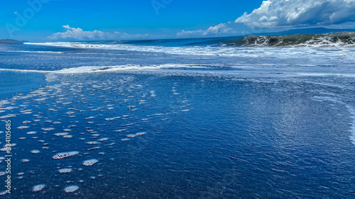 A desolate ocean shore with rolling waves. Background banner panorama © Smeilov