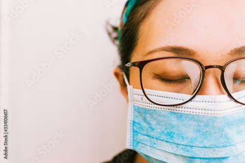 Asian Woman with Fogged Glasses Wearing a Mask Against Coronavirus