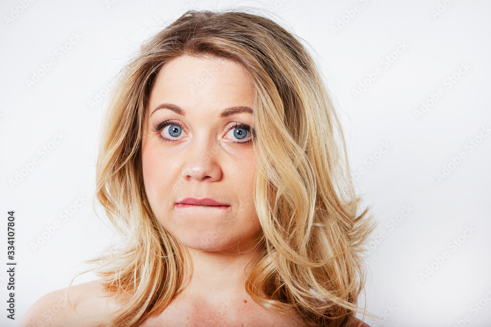 Isolated portrait of an upset woman. Sad female face. Young beautiful woman on a white background. Isolated portrait of an upset woman. Sad female face. Young beautiful woman on a white background.