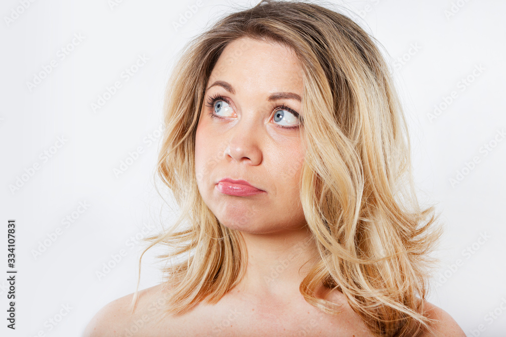 Isolated portrait of an upset woman. Sad female face. Young beautiful woman on a white background. Isolated portrait of an upset woman. Sad female face. Young beautiful woman on a white background.