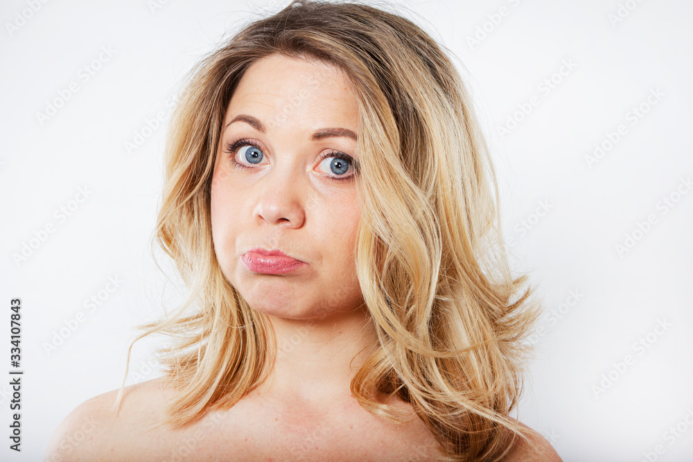 Isolated portrait of an upset woman. Sad female face. Young beautiful woman on a white background. Isolated portrait of an upset woman. Sad female face. Young beautiful woman on a white background.