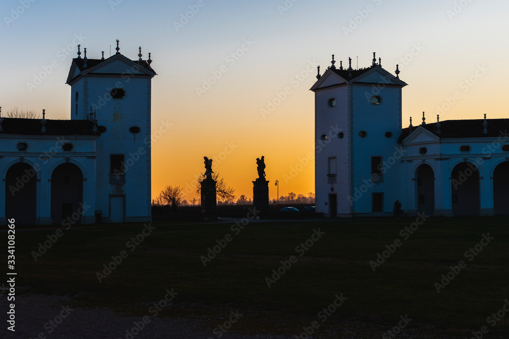 Sunset between the columns. Ancient residence of the Doge of Venice. Udine. Italy Sunset between the columns. Ancient residence of the Doge of Venice. Udine. Italy